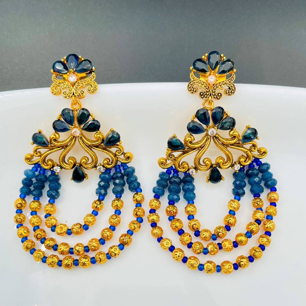 The Jewelbox Flower Wave Design 18K Gold Plated Blue Crystal Cubic Zirconia Beads Chandelier Earring For Women     			The Jewelbox Flower Wave Design 18K Gold Plated Blue Crystal Cubic Zirconia Beads Chandelier Earring For Women