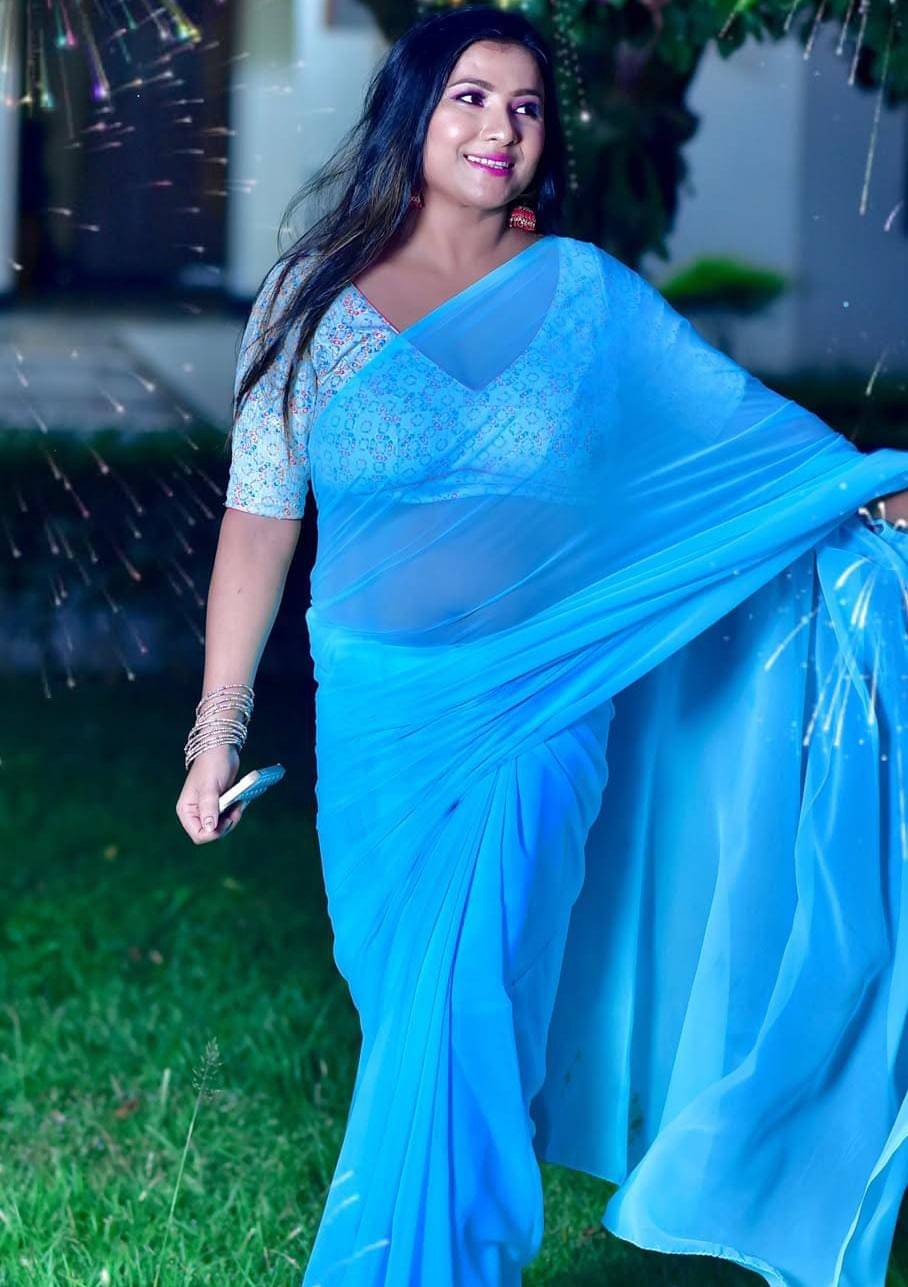 ANAND SAREES Georgette Solid Saree With Unstitched Blouse Piece ( Light Blue ) ANAND SAREES Georgette Solid Saree With Unstitched Blouse Piece ( Light Blue )