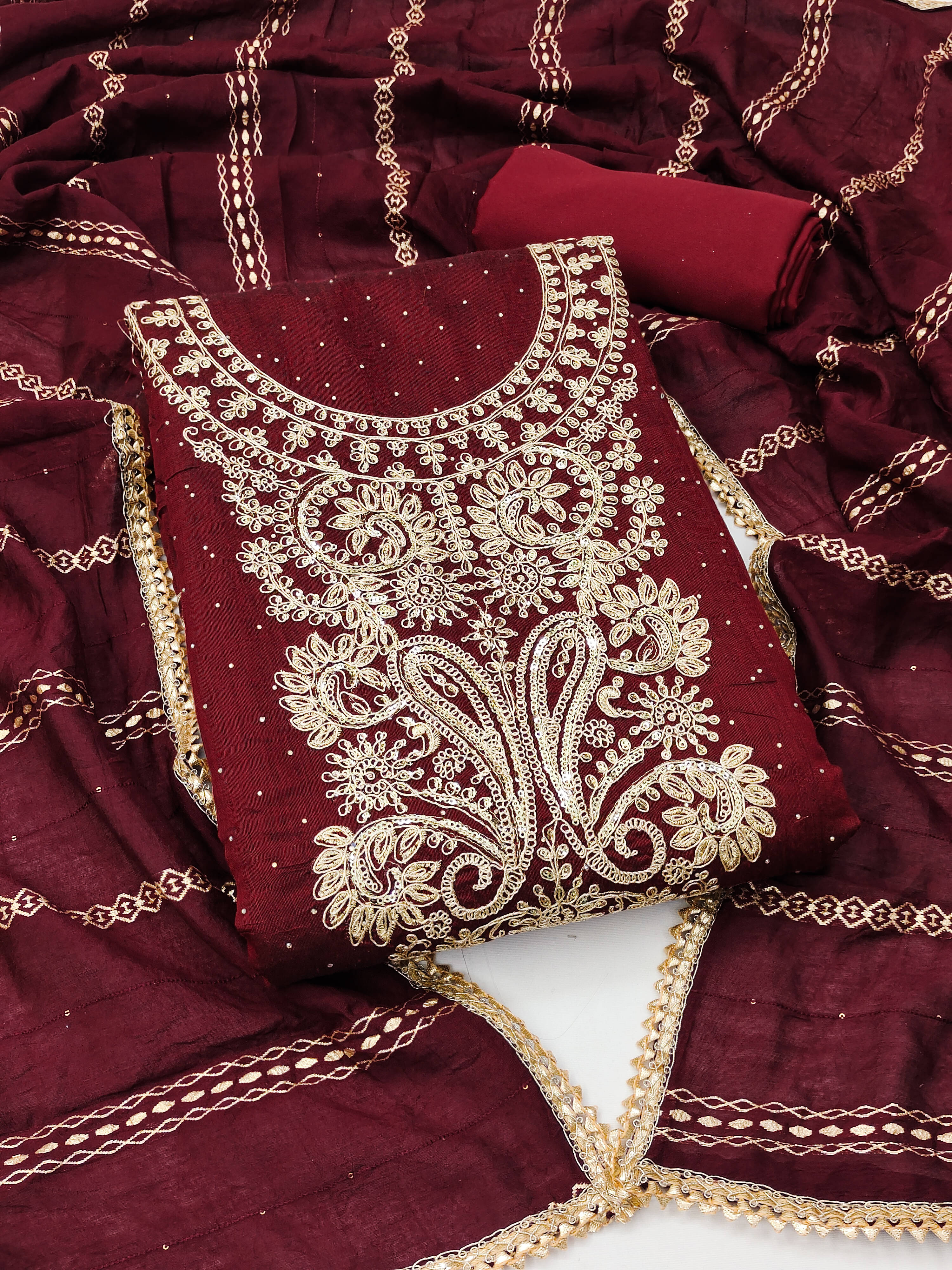 Nayanthara Trends Unstitched Chanderi Embellished Dress Material - Maroon ( Pack of 1 ) Nayanthara Trends Unstitched Chanderi Embellished Dress Material - Maroon ( Pack of 1 )
