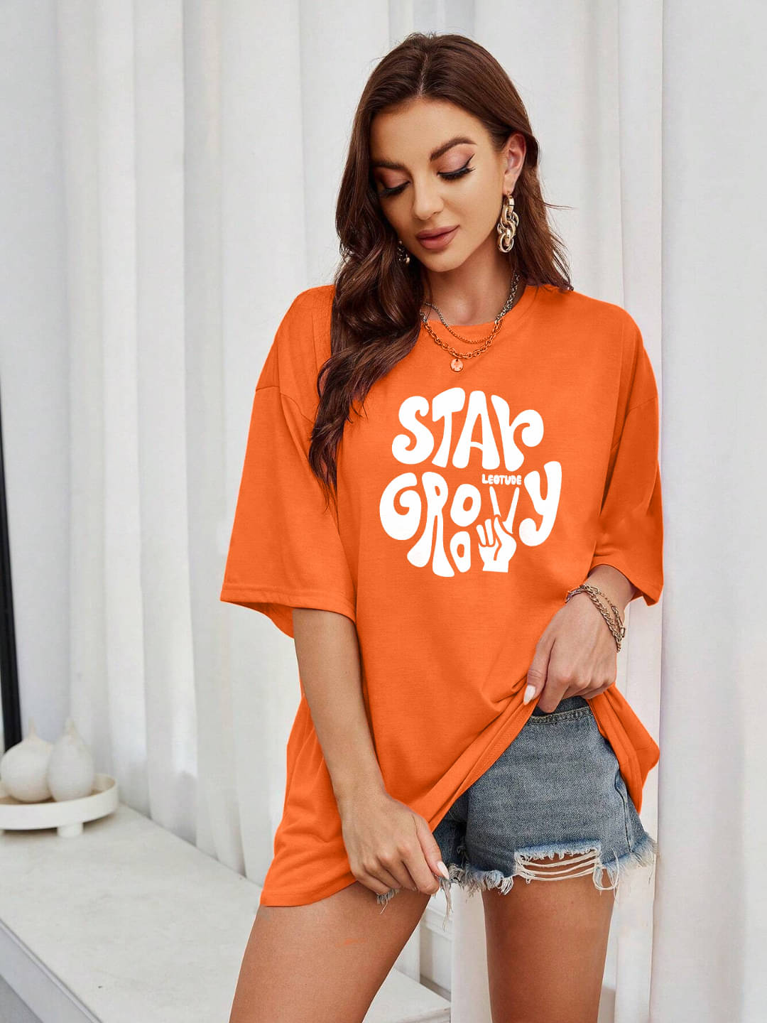     			Leotude Women Cotton Blend Printed Oversized Fit Round Neck T-Shirt ( Orange )