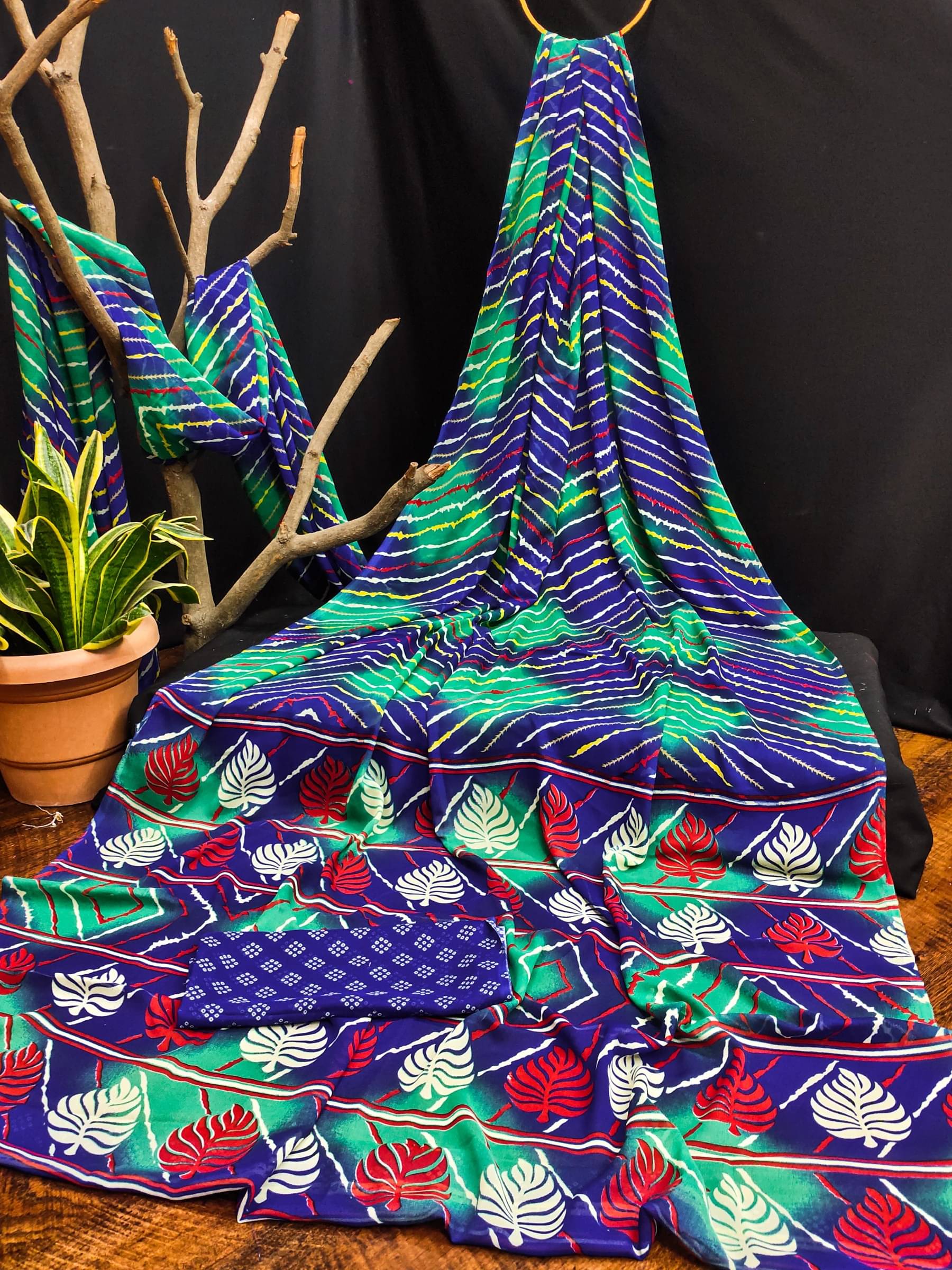 Kanooda Prints Georgette Printed Saree With Unstitched Blouse Piece ( Blue )     			Kanooda Prints Georgette Printed Saree With Unstitched Blouse Piece ( Blue )