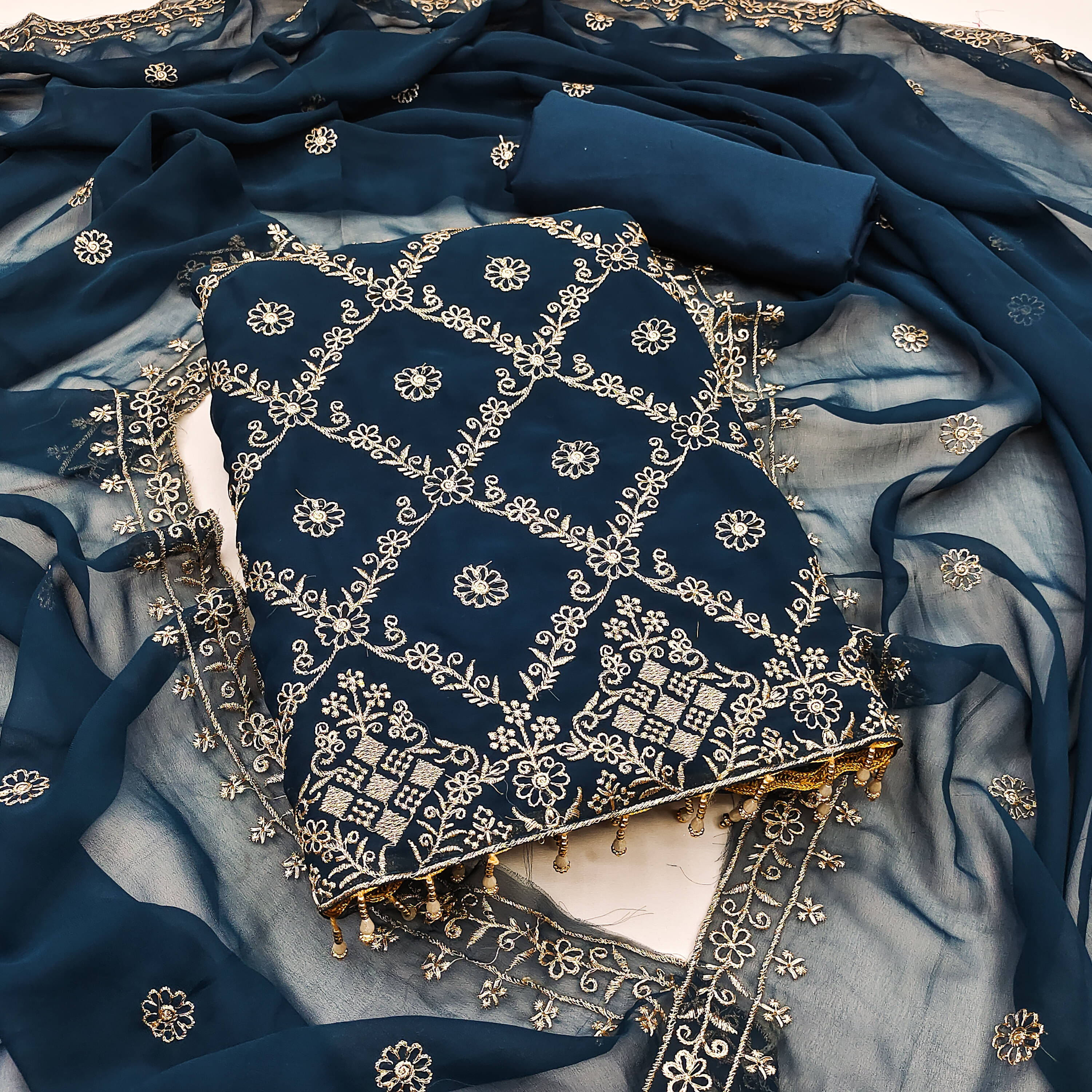 Nayanthara Trends Unstitched Georgette Embellished Dress Material - Teal ( Pack of 1 ) Nayanthara Trends Unstitched Georgette Embellished Dress Material - Teal ( Pack of 1 )