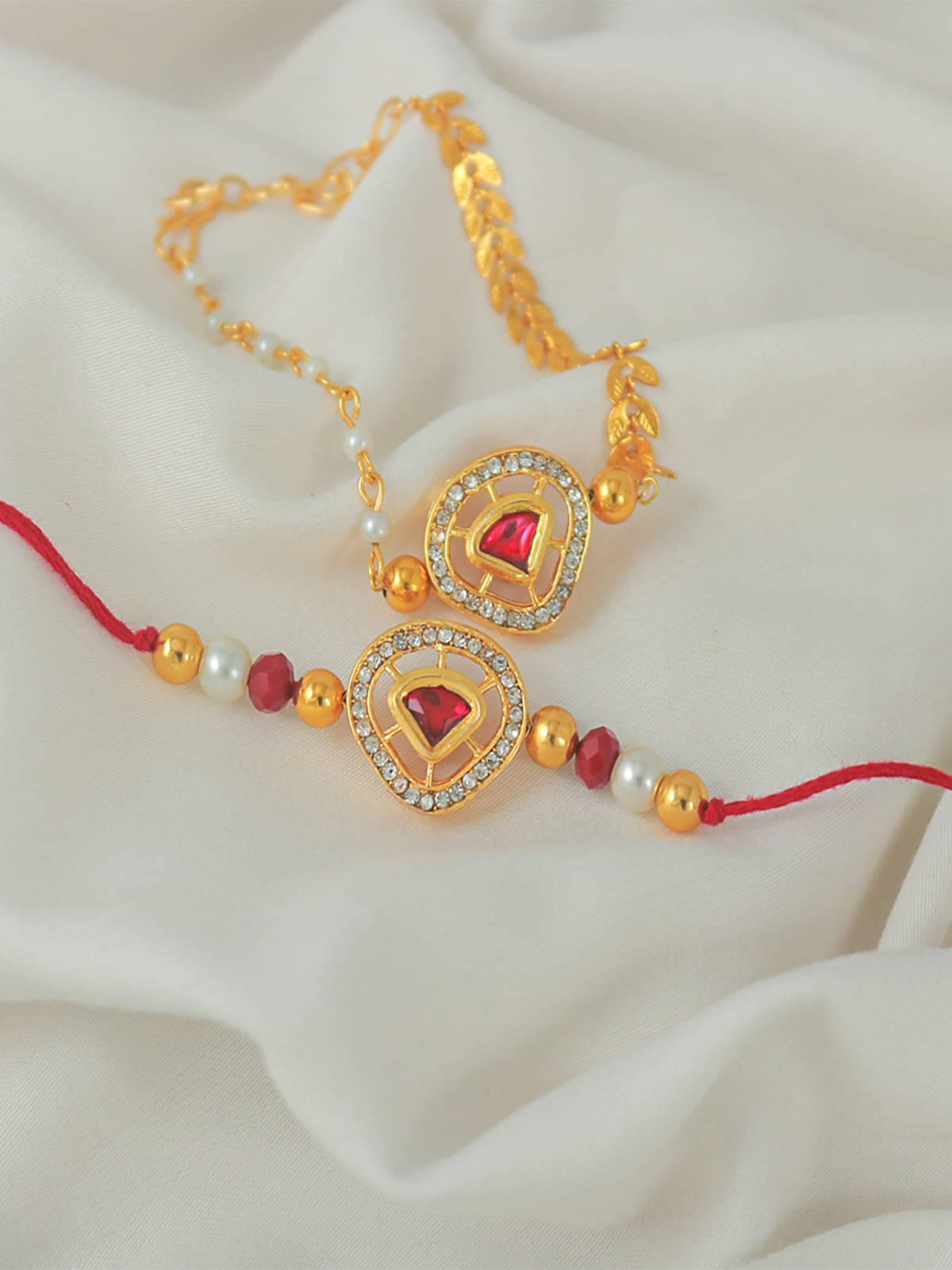     			Elegant Raksha Bandhan Combo of Red Kundan Rakhi and Lumba Set for Bhaiya Bhabhi with Roli Chawal and Written Greeting Note.