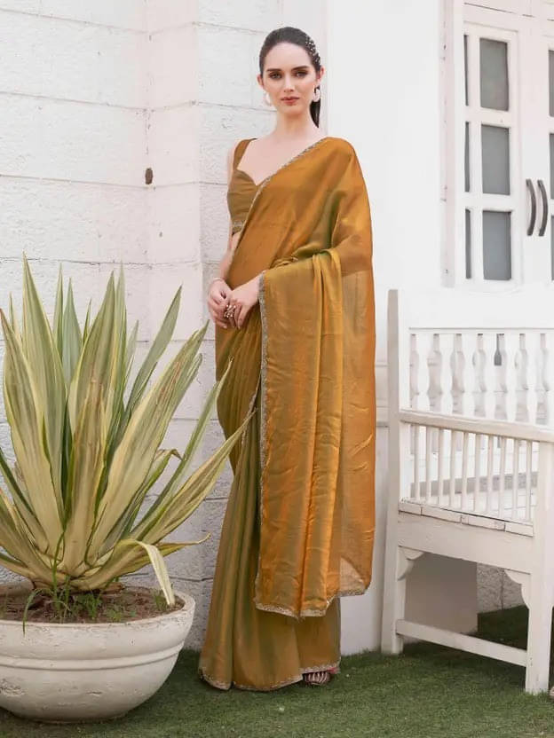 VRAGI Tissue Solid Regular Saree With Unstitched Blouse Piece ( Gold ) VRAGI Tissue Solid Regular Saree With Unstitched Blouse Piece ( Gold )
