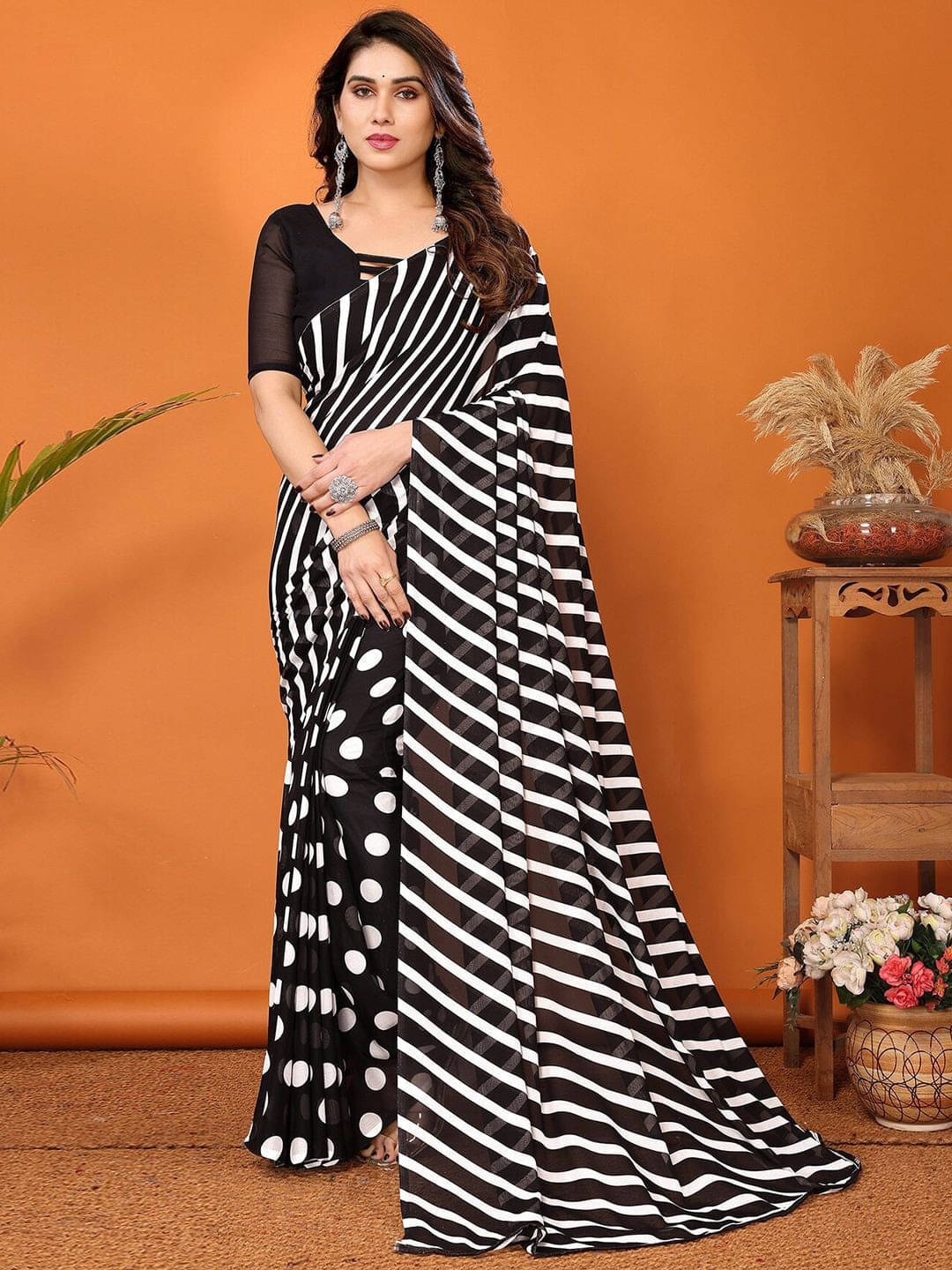 ANAND SAREES Georgette Printed Regular Saree With Unstitched Blouse Piece ( Black )     			ANAND SAREES Georgette Printed Regular Saree With Unstitched Blouse Piece ( Black )