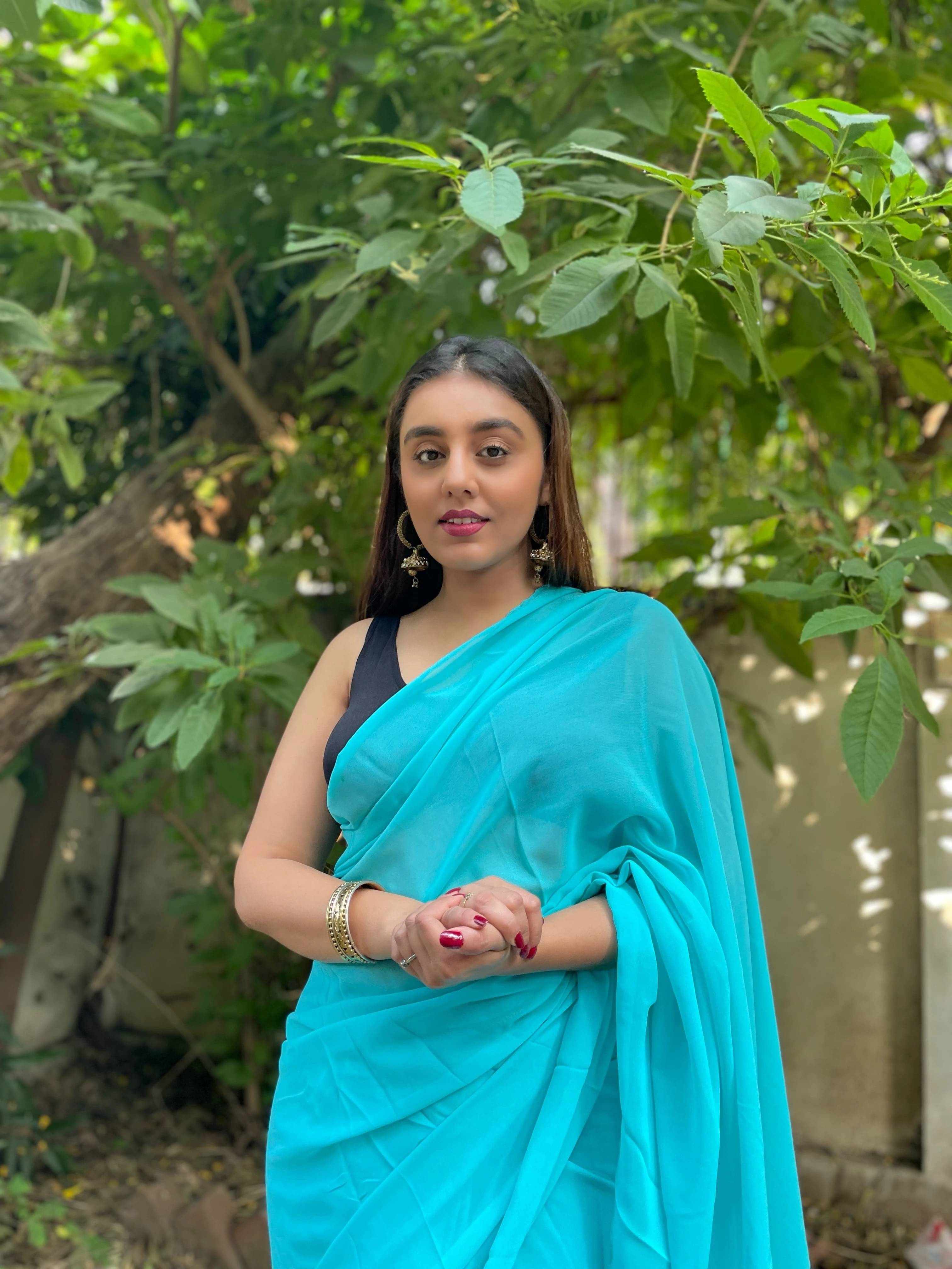 ANAND SAREES Georgette Solid Regular Saree With Unstitched Blouse Piece ( Light Blue ) ANAND SAREES Georgette Solid Regular Saree With Unstitched Blouse Piece ( Light Blue )