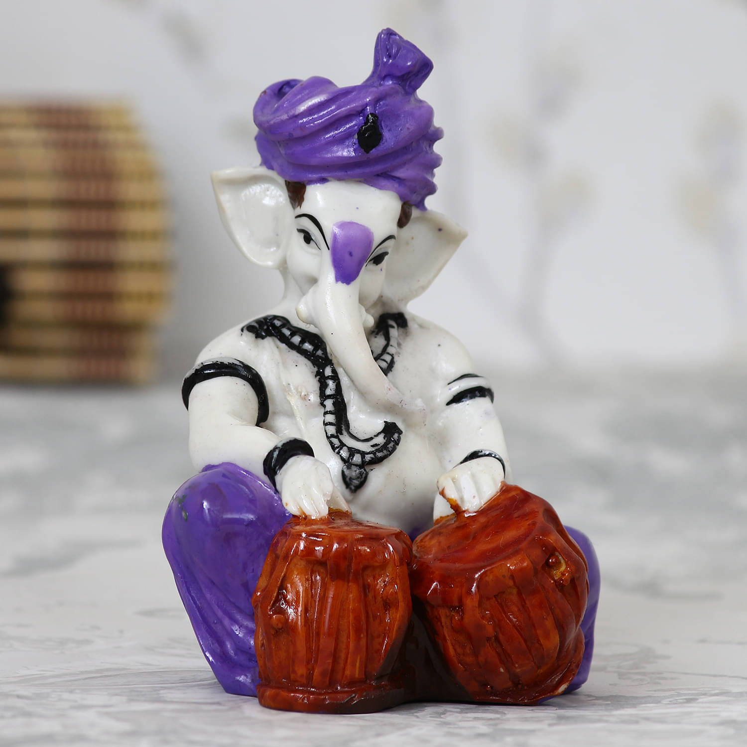 eCraftIndia White & Purple Handcrafted Lord Ganesha Playing Tabla Idol     			eCraftIndia White & Purple Handcrafted Lord Ganesha Playing Tabla Idol