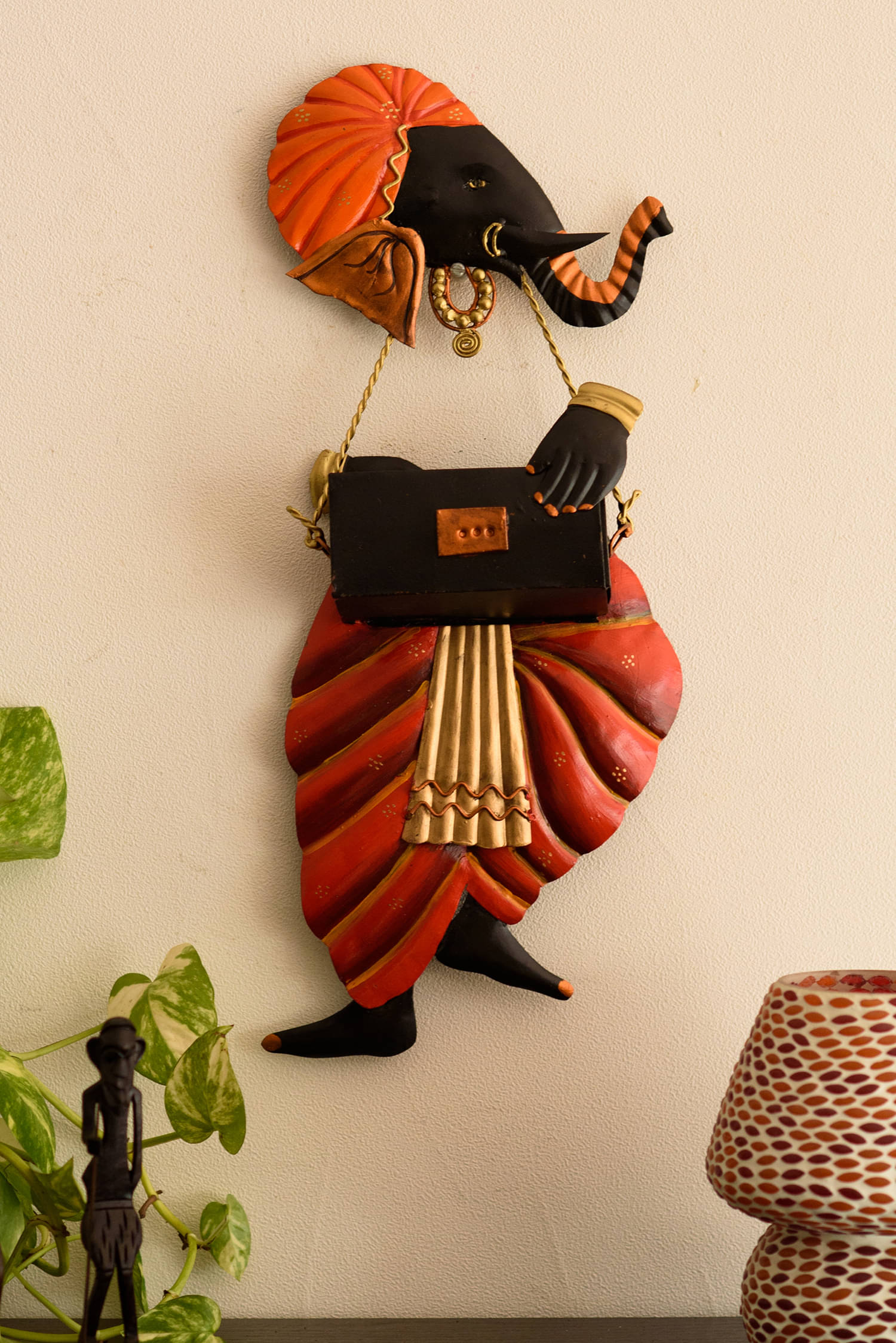 eCraftIndia Orange & Black Ganesha Playing Harmonium Wall Hanging     			eCraftIndia Orange & Black Ganesha Playing Harmonium Wall Hanging
