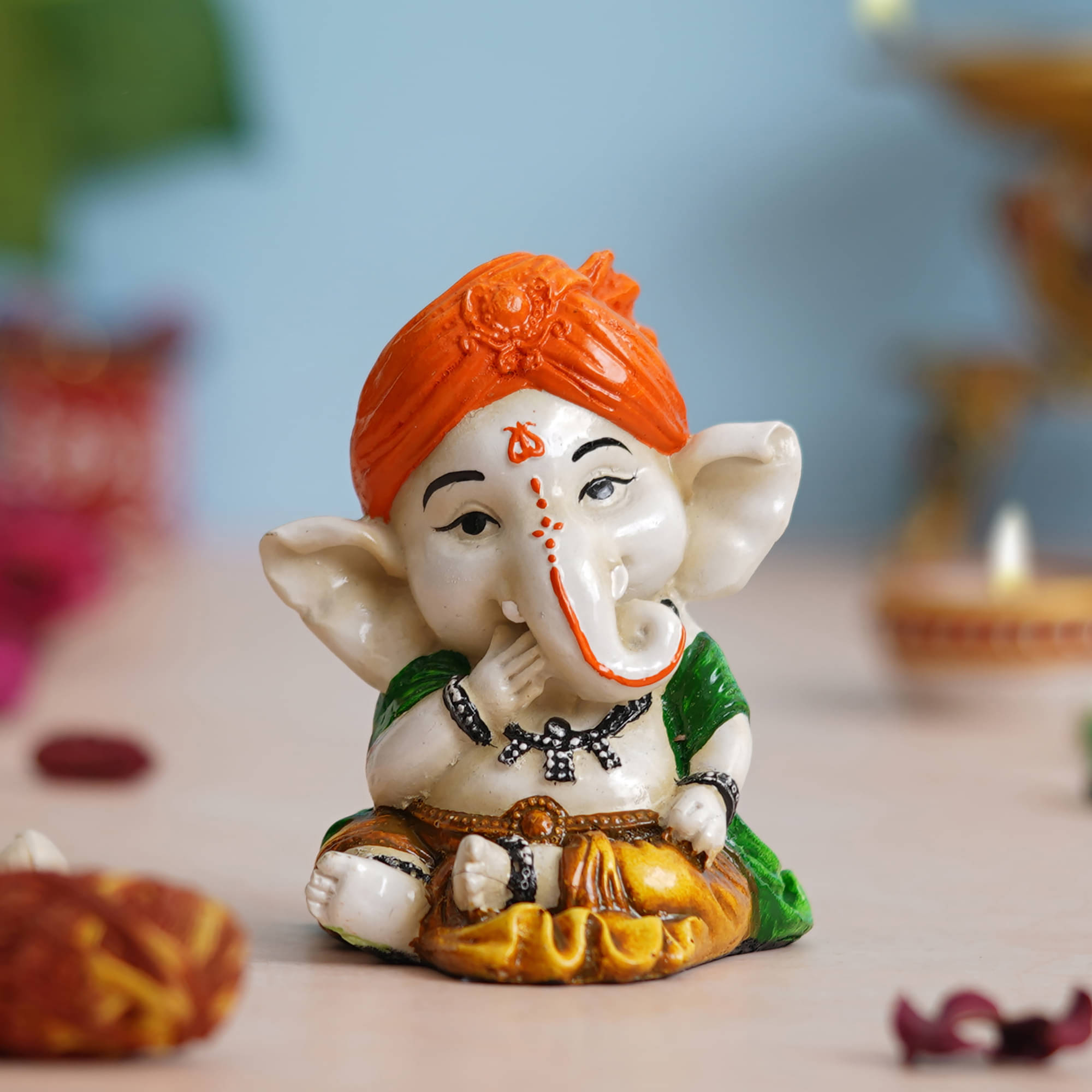     			eCraftIndia Orange & White Eating Lord Ganesha Idol While Sitting Polyresin Showpieces