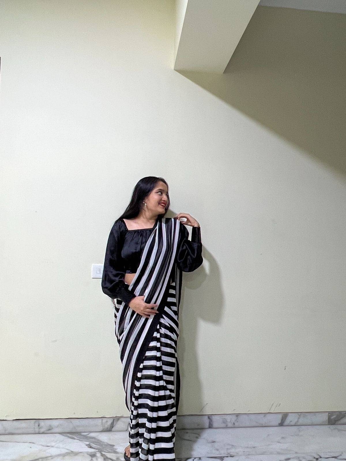 ANAND SAREES Georgette Printed Saree With Unstitched Blouse Piece ( Black ) ANAND SAREES Georgette Printed Saree With Unstitched Blouse Piece ( Black )